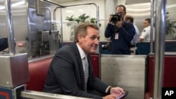 Sen. Jeff Flake, R-Ariz., boards the subway on Capitol Hill in Washington, Thursday, Nov. 30, 2017. 