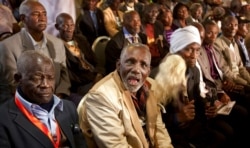 FILE - Mau Mau veterans listen at a press conference announcing a settlement in their legal case for compensation against the British government, in Nairobi, Kenya, June 6, 2013.