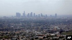 FILE - EPA officials set to announce new standards on Friday; above, smog covers downtown Los Angeles, Calif., April 2009.