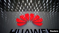 FILE - A Huawei company logo is displayed at Shenzhen International Airport, in Shenzhen, Guangdong province, China, July 22, 2019.