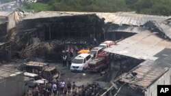 Petugas kepolisian dan petugas penyelamat memeriksa lokasi ledakan petasan