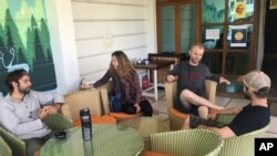 Australian tourist Stewart Dufty, 44, second right, talks with other stranded foreign tourists at a hostel in New Delhi, India, April 2, 2020.