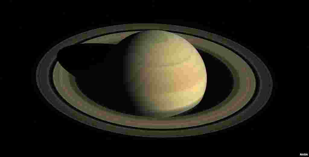 This Aug. 12, 2009 composite image made available by NASA shows Saturn in equinox seen by the approaching Cassini spacecraft. Saturn&#39;s equinox occurs only once in about 15 Earth years.