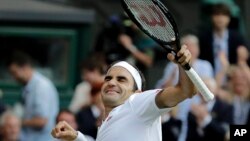 Switzerland's Roger Federer celebrates defeating Spain's Rafael Nadal during a men's singles semifinal match on day eleven of the Wimbledon Tennis Championships in London, Friday, July 12, 2019. (AP Photo/Ben Curtis)