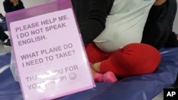 Gloria, a 22-year-old migrant from Honduras 8 months pregnant with her first child, sits on a cot in the Humanitarian Respite Center run by Catholic Charities across the bus station in McAllen, Texas, on Dec. 15, 2022.