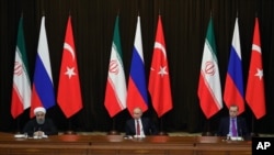 FILE - Turkey's President Recep Tayyip Erdogan, right, Russia's President Vladimir Putin, center, and Iran's President Hassan Rouhani are seen at a news conference following their talks on Syria, in Russia's Black Sea resort of Sochi, Russia, Nov. 22, 2017. The three will be meeting in Ankara, Turkey, Wednesday.