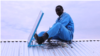 A worker installs a BBOXX solar panel on a rooftop in Kakuma, a refugee camp in northwest Kenya. (M. Yusuf/VOA)