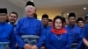 FILE - Former Malaysian Prime Minister Najib Razak, second left in front, and his wife Rosmah Mansor prepare to leave for an election nomination center in Pekan, Pahang state, Malaysia, April 28, 2018. 