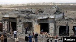 People gather at the site of Saudi-led air strikes in Arhab area, around 20 kilometres (13 miles) north of Sana'a, Aug. 23, 2017.