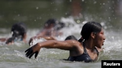 An indigenous woman competes in a swimming competition during the first World Games for Indigenous Peoples in Palmas, Brazil, Oct. 30, 2015. (Photo REUTERS/Ueslei Marcelino)