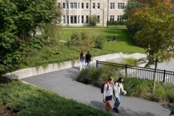 FILE - College students wear masks out of concern for the coronavirus on the Boston College campus, Sept. 17, 2020, in Boston.
