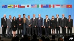 Trade delegates pose for a photograph after signing the Trans-Pacific Partnership Agreement in Auckland, New Zealand, February 4, 2016. Trade ministers from 12 Pacific Rim countries including the United States have ceremonially signed the free-trade deal. (David Rowland/SNPA via AP) 