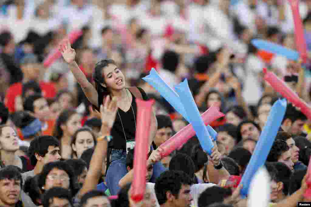 Youths sing and dance as they wait for the arrival of Pope Francis in Asuncion, Paraguay, July 12, 2015. 