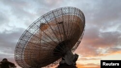 A radio telescope at the Parkes Observatory is pictured at sunset near the town of Parkes, Australia, July 15, 2019. 