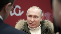 Russian President Vladimir Putin speaks with journalists as he attends a concert marking the seventh anniversary of Russia's annexation of Crimea at Luzhniki Stadium in Moscow, Russia, March 18, 2021.