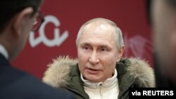 Russian President Vladimir Putin speaks with journalists as he attends a concert marking the seventh anniversary of Russia's annexation of Crimea at Luzhniki Stadium in Moscow, Russia, March 18, 2021.