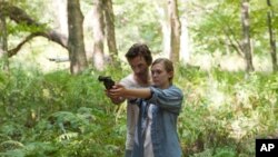 John Hawkes portrays a cult leader and Elizabeth Olsen is the young woman who escapes him in “Martha Marcy May Marlene.”