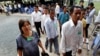 Cambodians enter the court entrance before a delivering verdict of two surviving leaders Khieu Samphan and Noun Chea, at the U.N.-backed war crimes tribunal in Phnom Penh, Cambodia, Thurdday, Aug. 7, 2014. Three and a half decades after the genocidal rule