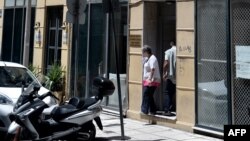A woman exits the Russia Consulate building in Thessaloniki, on July 11, 2018.