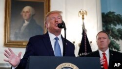 President Donald Trump, accompanied by Secretary of State Mike Pompeo, speaks Oct. 23, 2019, in the Diplomatic Room of the White House in Washington. 