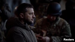 Ukraine's President Volodymyr Zelenskyy visits Ukrainian service members at their position in the frontline town of Bakhmut, amid Russia's attack on Ukraine, in Donetsk region, Ukraine Dec. 20, 2022. 