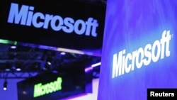 A variety of logos hover above the Microsoft booth on at the International Consumer Electronics Show in Las Vegas, January 10, 2012.