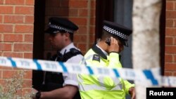 A police officer stands outside a property being searched after a man was arrested in connection with an explosion on a London Underground train, in Stanwell, near Heathrow airport, Britain, Sept. 17, 2017. 