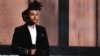 The Weeknd introduces a performance by Pharrell Williams at the 57th annual Grammy Awards, Feb. 8, 2015, in Los Angeles. 