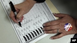 A voter, who did not wish to be identified, votes on Election Day at the Holland Land Office Museum in Batavia, N.Y., Tuesday, Nov. 6, 2012.