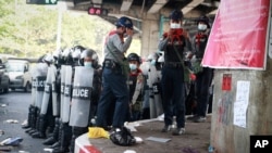 Police stand in formation as they prepare to disperse protesters during a rally against the military coup in Yangon, Myanmar, Feb. 26, 2021. 
