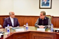 Pakistan's Foreign Minister Shah Mehmood Qureshi, right, meets U.S. envoy Zalmay Khalilzad in Islamabad, Pakistan, Jan. 31, 2020. Khalilzad has met with Pakistan's foreign minister to find a peaceful solution to neighboring Afghanistan's war.