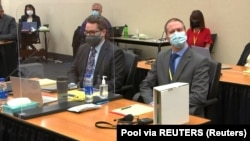 Former Minneapolis police officer Derek Chauvin (R) listens at the opening of his trial for murder of George Floyd in Minneapolis, Minnesota, March 29, 2021, in a still image from video.
