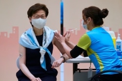 In this Monday, March. 22, 2021, photo, Hong Kong Chief Executive Carrie Lam receives the second dose of the Sinovac Biotech COVID-19 vaccine at a Central Government office in Hong Kong.
