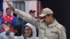 President Nicolas Maduro, and First Lady Cilia Flores wave to supporters during an event marking the 165th anniversary of the Battle of Santa Ines, in Caracas, Venezuela, Dec. 10, 2024.