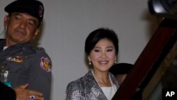 Thailand's former Prime Minister Yingluck Shinawatra, arrives at parliament in Bangkok, Thailand Thursday, Jan. 22, 2015.