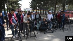 FILE - Journalists gather for a news event at Shahr-e-Naw Park in Kabul, Afghanistan, April 30, 2019.