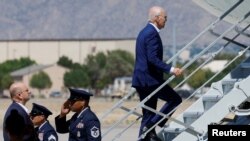 U.S. President Joe Biden boards Air Force One for travel to Utah from Kirtland Air Force Base in Albuquerque, New Mexico, Aug. 9, 2023. A Utah man accused of making threats against him was shot and killed before the president was expected to land there.