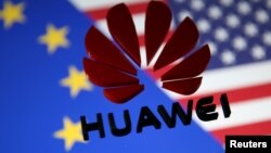FILE — A 3D printed Huawei logo is placed on glass above a display of EU and US flags in this illustration taken Jan. 29, 2019. 