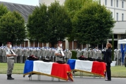 FILE - French Defense Minister Florence Parly pays tribute to two French soldiers with the anti-jihadist Barkhane force in Mali killed when their armored vehicle hit an improvised explosive device, during a tribute ceremony in Tarbes, Sept. 9, 2020.