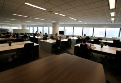 People work in an office where the majority of staff work remotely, amid the coronavirus disease (COVID-19) pandemic in Tokyo, Japan August 7, 2020.