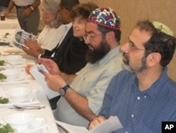 Jews and Muslims, seated side-by-side, share their thoughts during a Passover Seder at the All Dulles Area Muslim Society (ADAMS).