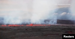 A view shows lava spewing from Hawaii's Mauna Loa volcano, Mauna Loa, Hawaii, U.S., November 28, 2022 in this screen grab taken from a handout video. (Mick Kalber Tropical Visions Video/Handout via REUTERS