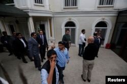 Saudi officials arrive at the residence of Saudi Arabia's Consul General Mohammad al-Otaibi in Istanbul, Oct. 17, 2018.