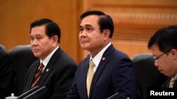 FILE - Thailand's Prime Minister Prayuth Chan-ocha (C).