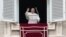 Pope Francis waves to faithful during the Angelus noon prayer in St. Peter's Square, at the Vatican, Jan. 6, 2022.