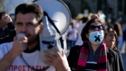 State hospital workers marched through central Athens as part of a 24-hour strike to protest staff shortages and compulsory vaccinations against COVID-19, Dec. 1, 2021