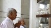 Survivors of the Khmer Rouge regime, Chum Mey (L) and Bou Meng (C) pray at Choeung Ek "Killing Fields" site located on the outskirts of Phnom Penh, June 25, 2011.