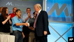 President Donald Trump shakes hands as he arrives to speak to the National Association of Manufactures at the Mandarin Oriental hotel, Sept. 29, 2017, in Washington.