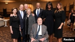 Former U.S. Presidents and former U.S. first ladies Laura Bush, George W. Bush, Bill Clinton, Hillary Clinton, Barack Obama, Michelle Obama, and first lady Melania Trump pose with former U.S. President George H.W. Bush at the funeral of Barbara Bush in Houston.