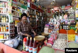 Afghan Sikh Jagtar Singh Laghmani, 50, sits at his traditional herb shop in Kabul, Afghanistan, June 19, 2016.